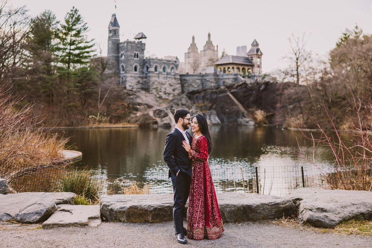 A couple sharing a laugh together in front of the belvedere castle at central park