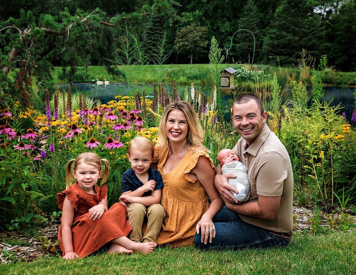 family sitting with newborn girl