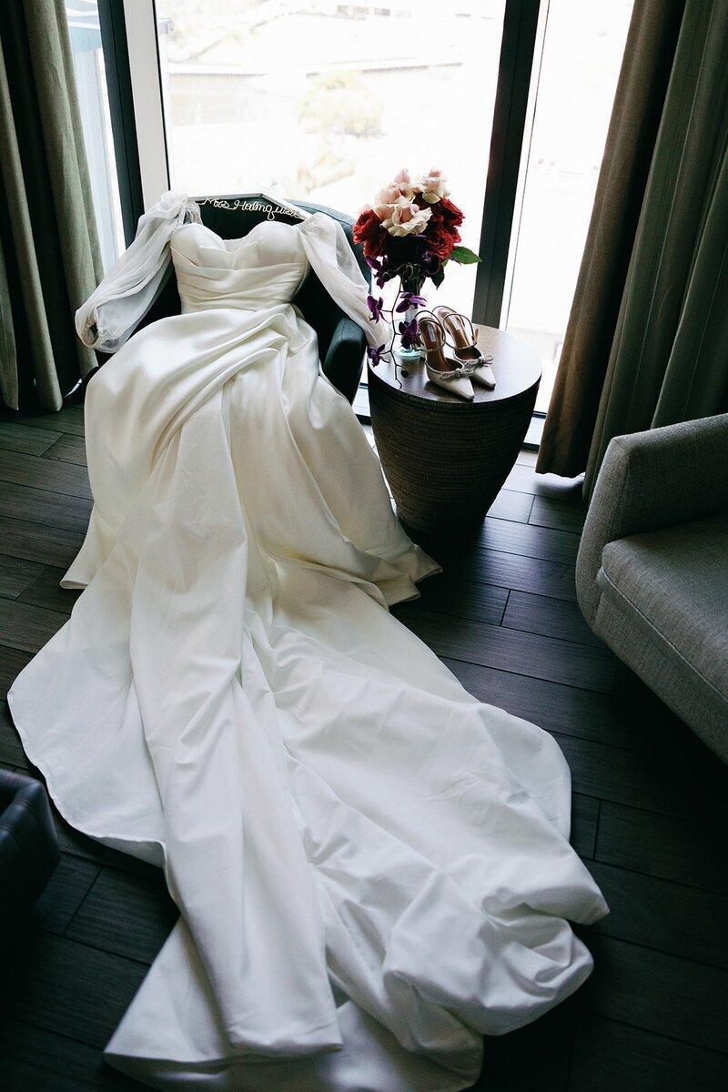penthouse at riverside wharf photos of dress, shoes, and flowers at wedding