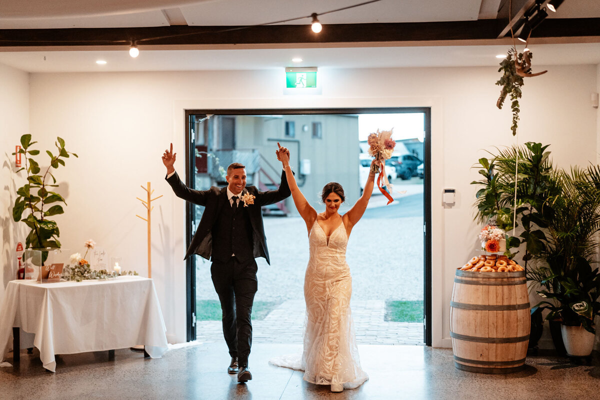 Mikaeley & Lachlan having fun getting into their wedding reception