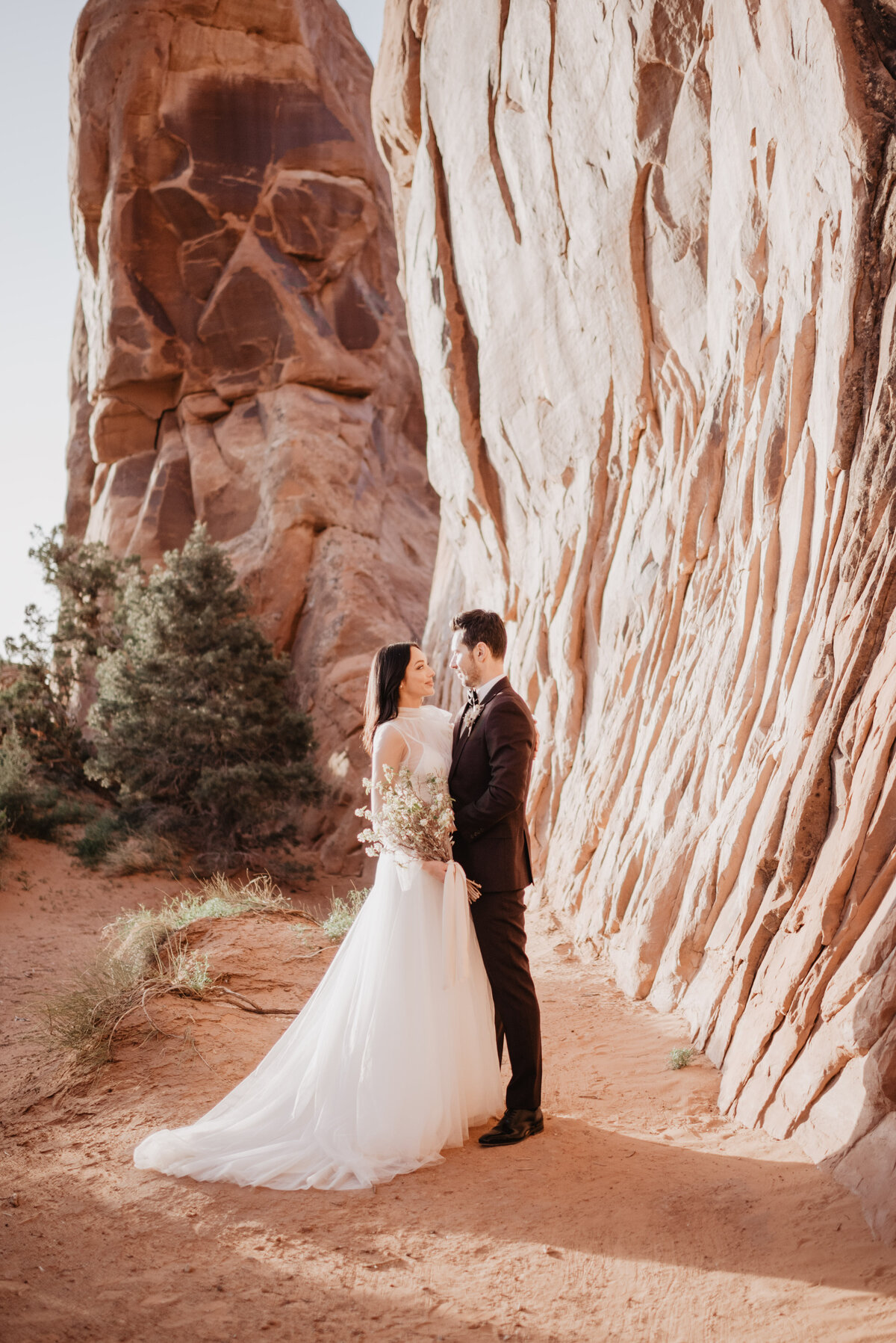 Utah elopement photographer captures couple hugging and looking at one another