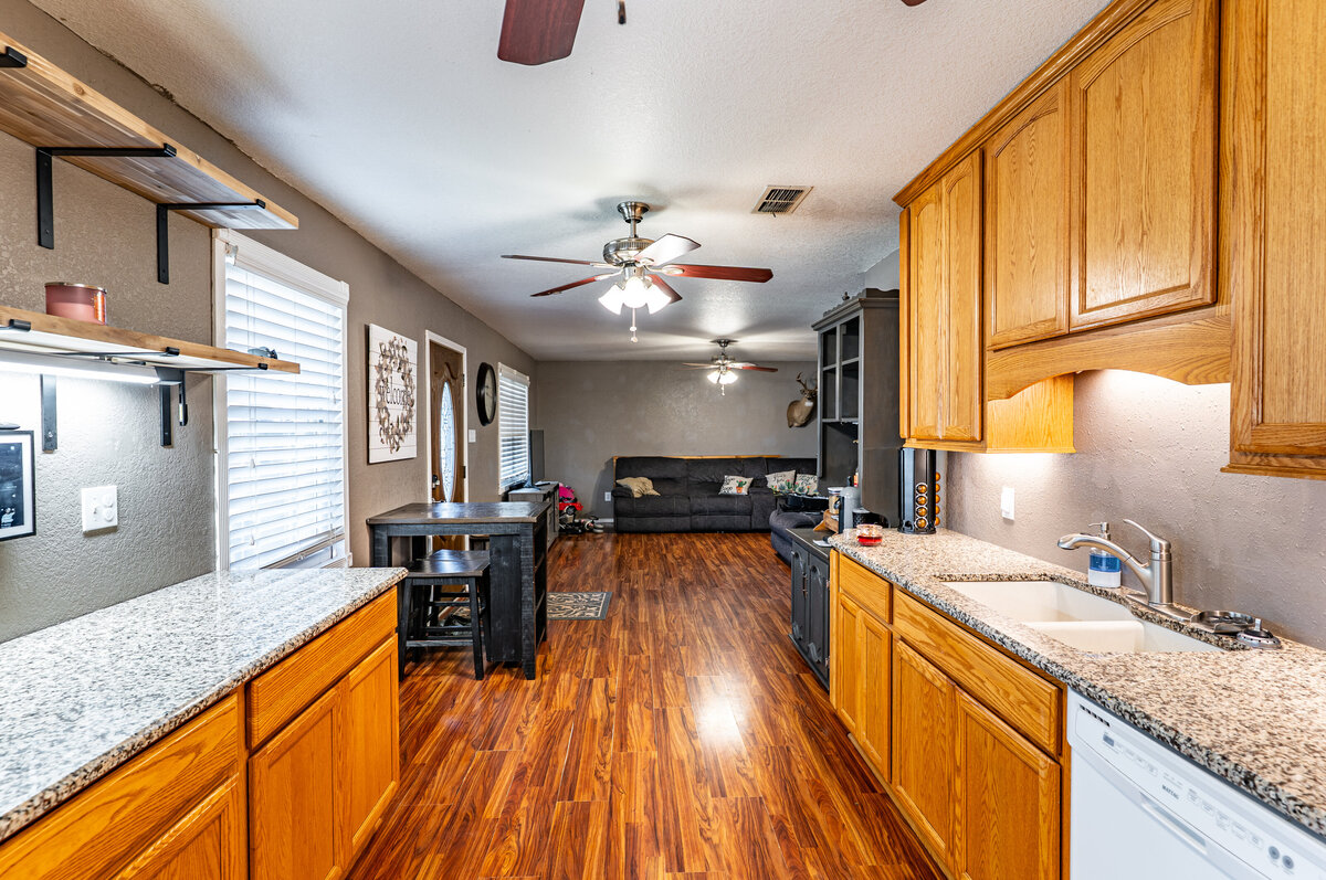 kitchen with granite countertops and under cabinet lighting