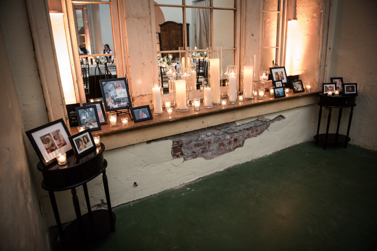 Candles and framed family pictures on ledge at Latrobes