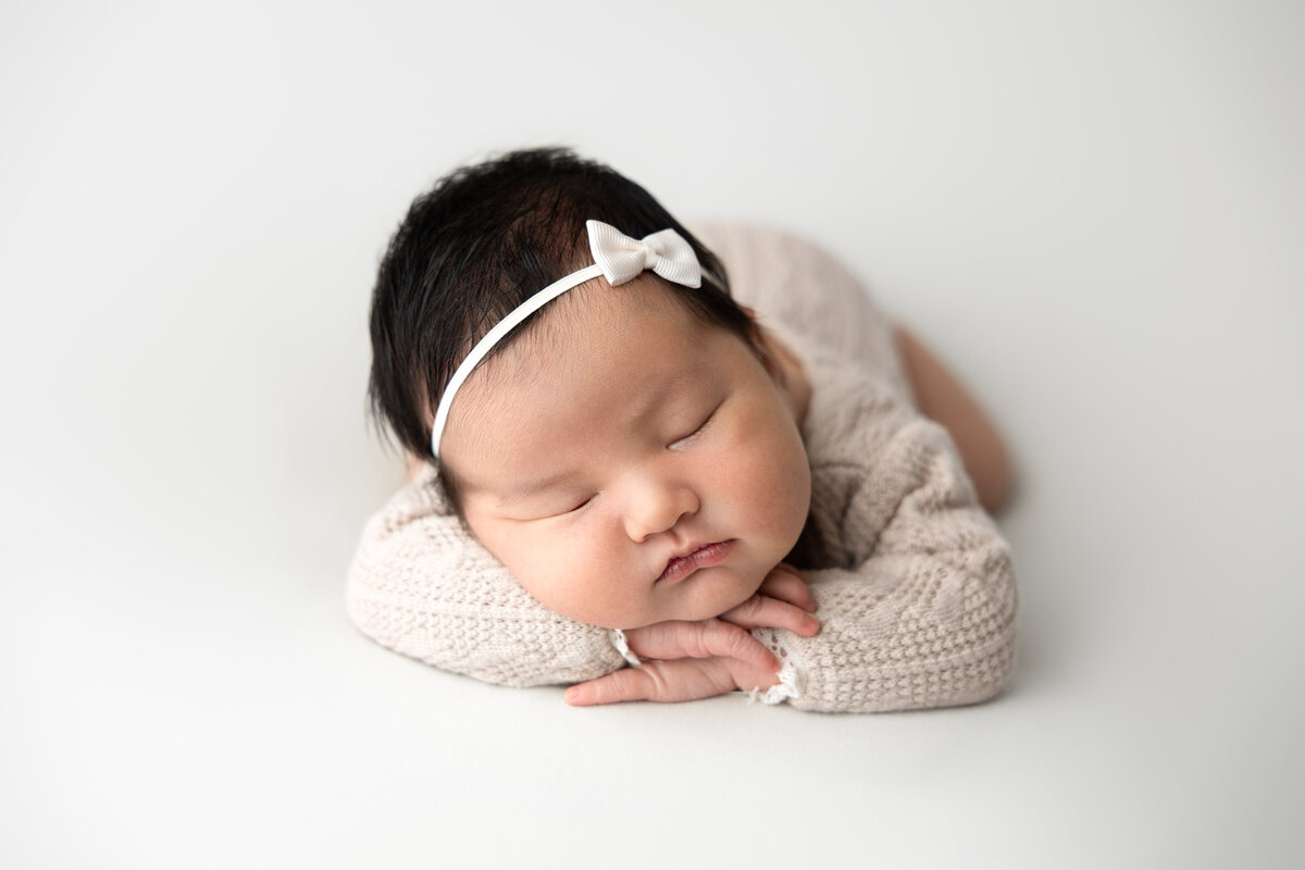 Newborn baby girl on white backdrop  Edmonton studio photography 