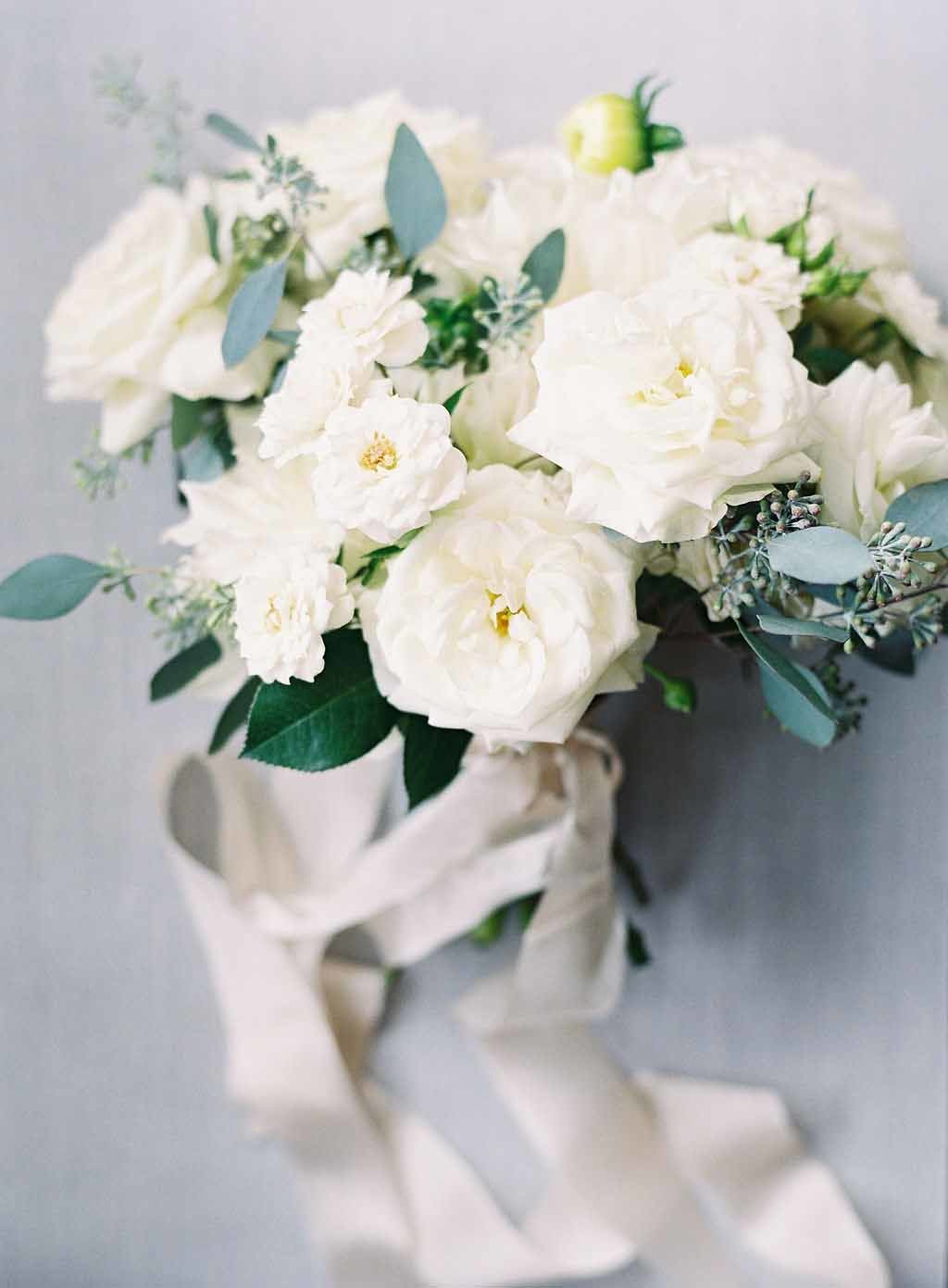 bridal bouquet of white garden roses, garden spray roses, and eucalyptus greenery with ivory ribbon streamers