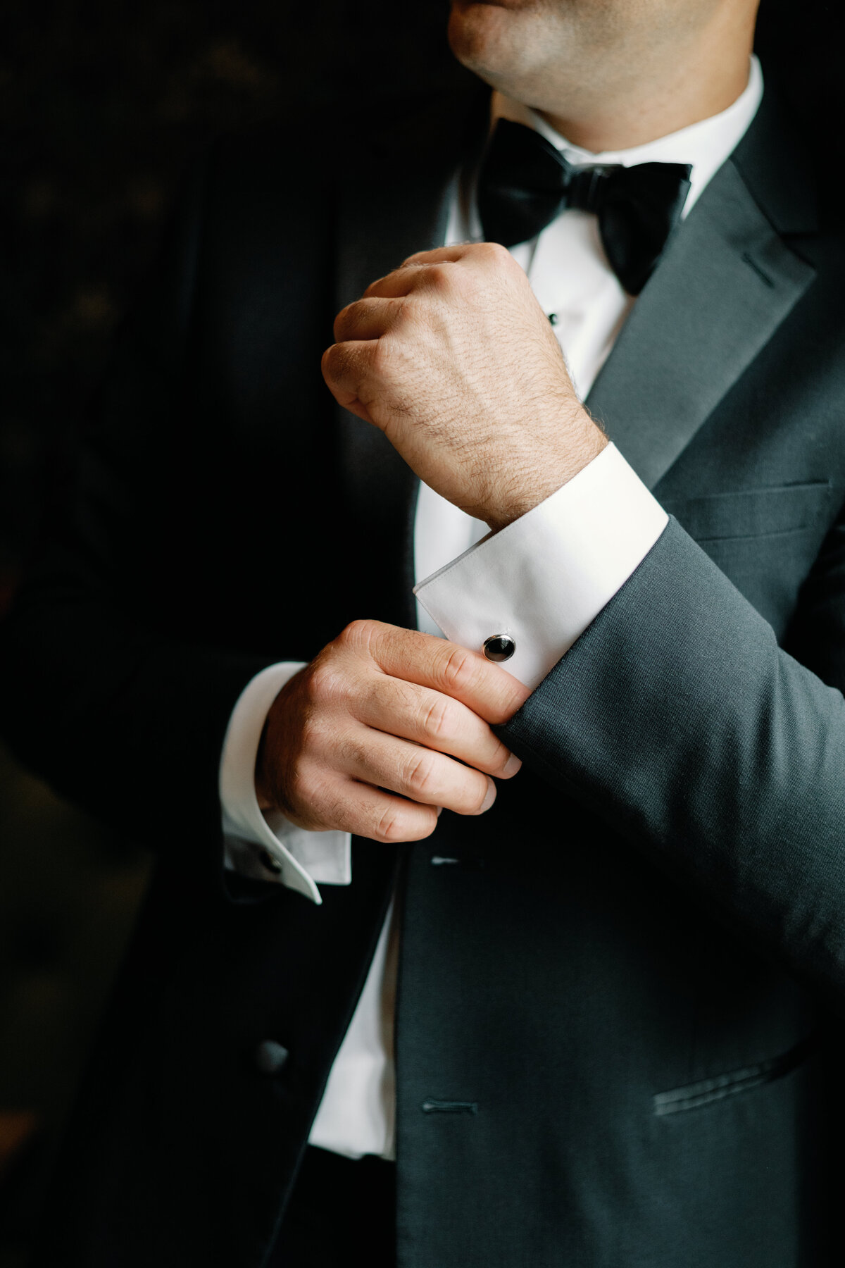 Grooom showing his cufflinks by Lacey Graham Wedding Photographer in Illinois