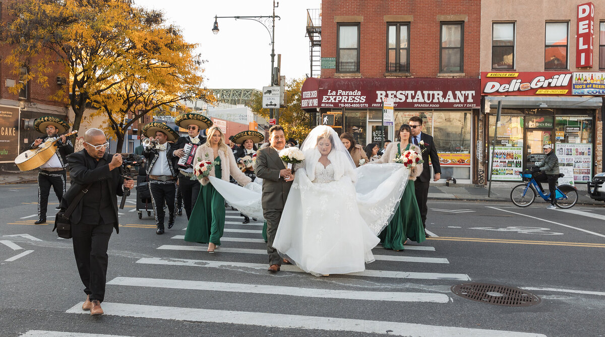 Mexican bride, bridal party at the Brooklyn streets with Mariachi band playing as they walk to church.