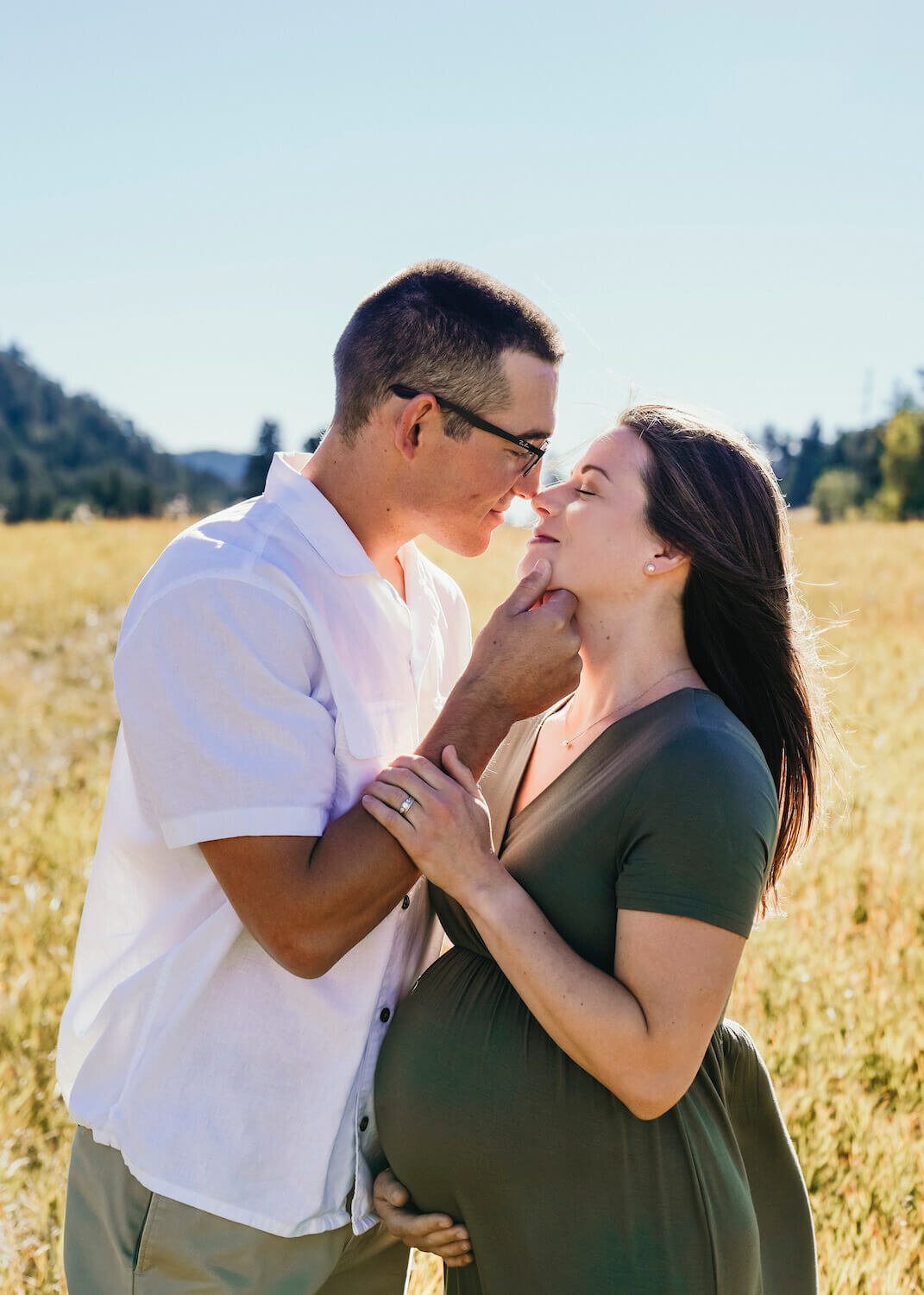 denver maternity photography - couple smiling in field