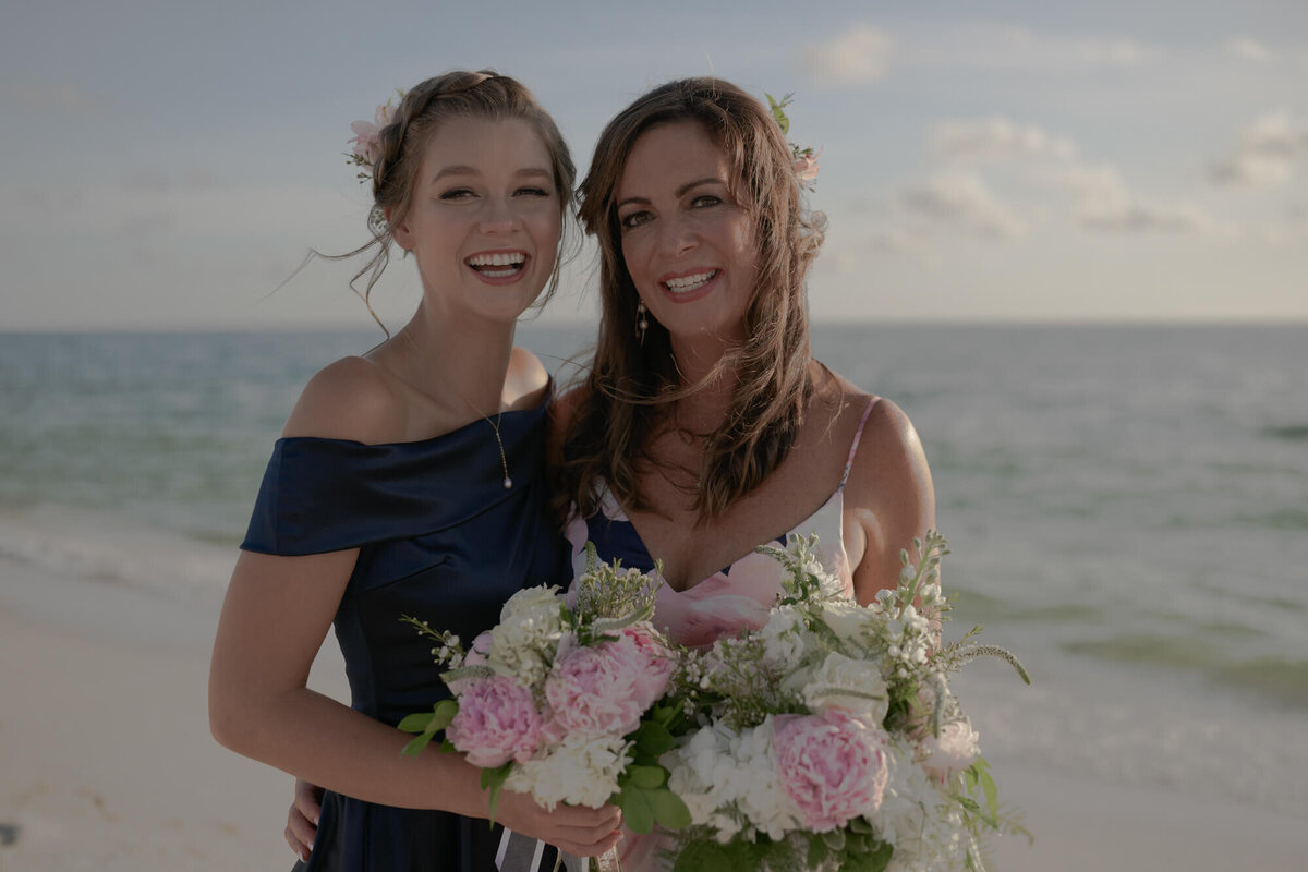 Bride and daughter at beach wedding