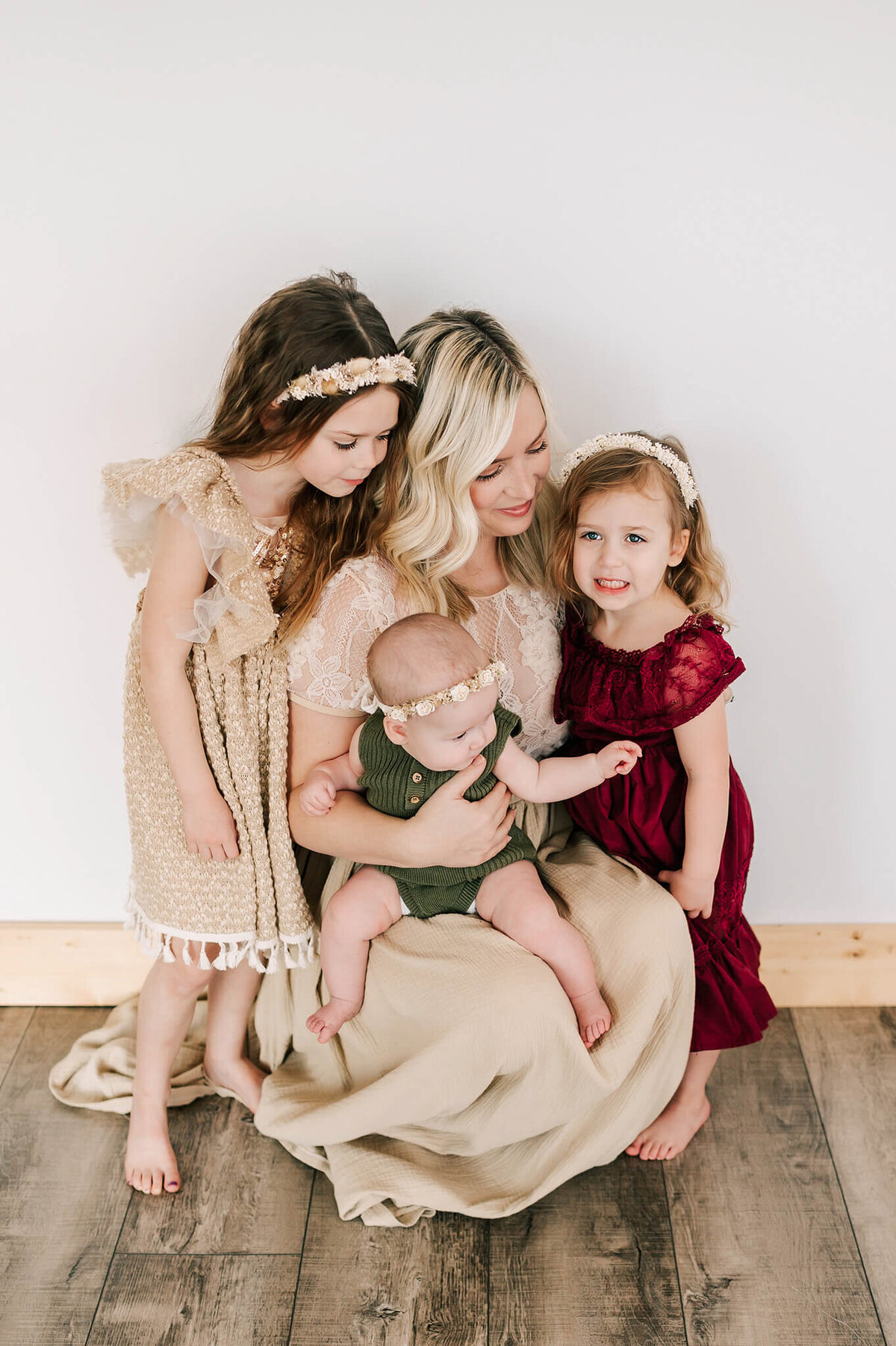 mom cuddling kids in family photography studio in Branson