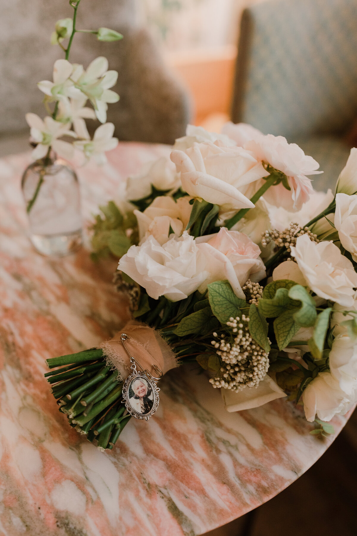 Bride bouquet of white florals and vintage brooch for intimate Austin wedding