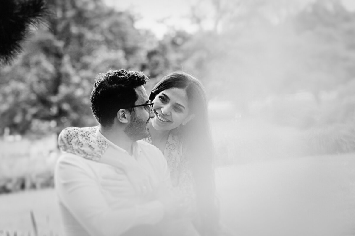 black-and-white-image-of-an-engaged-couple-sitting-by-the-zen-garden-at-the-experimental-farm-in-ottawa-1