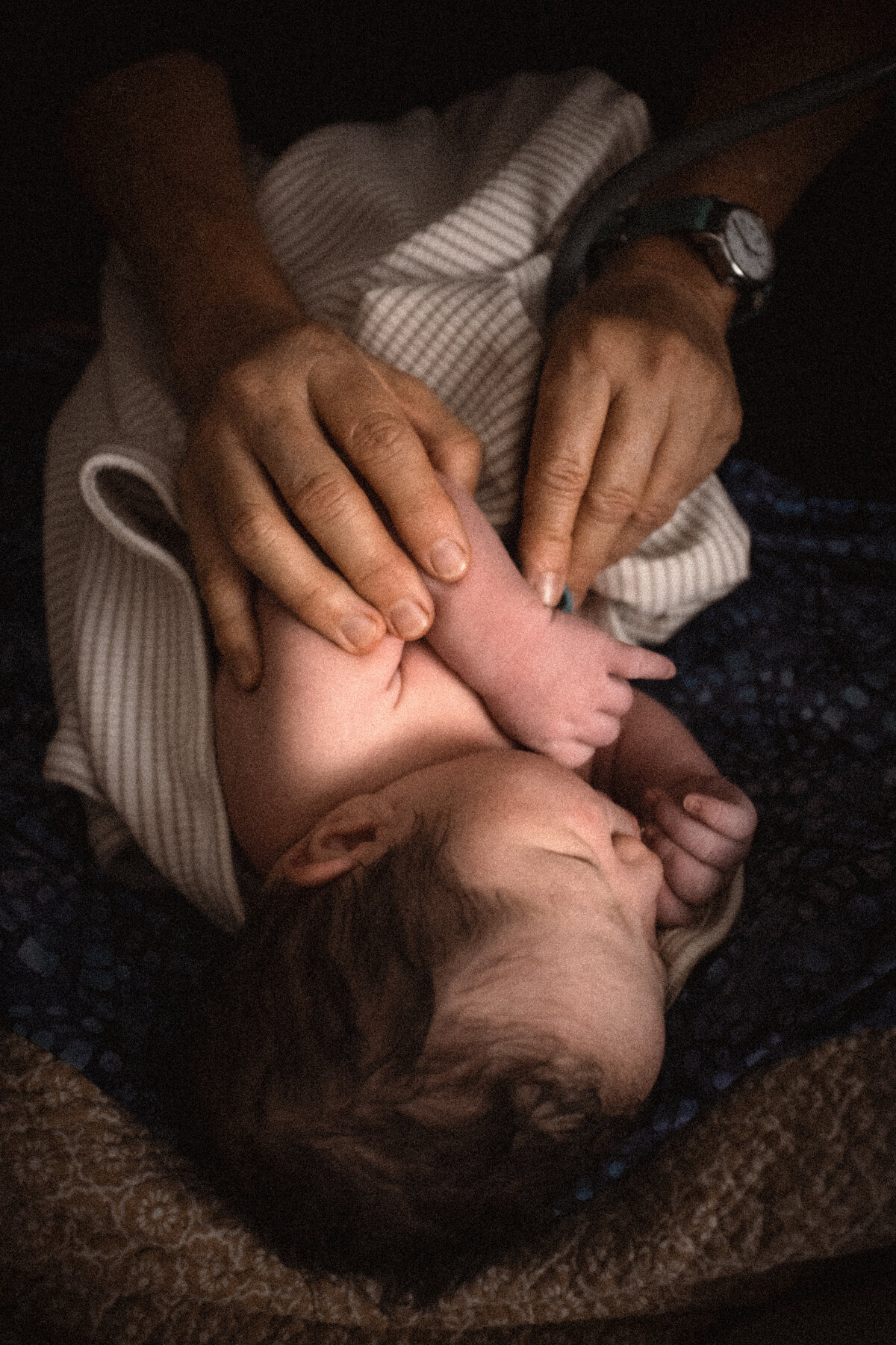 homebirth midwife assessing newborn baby