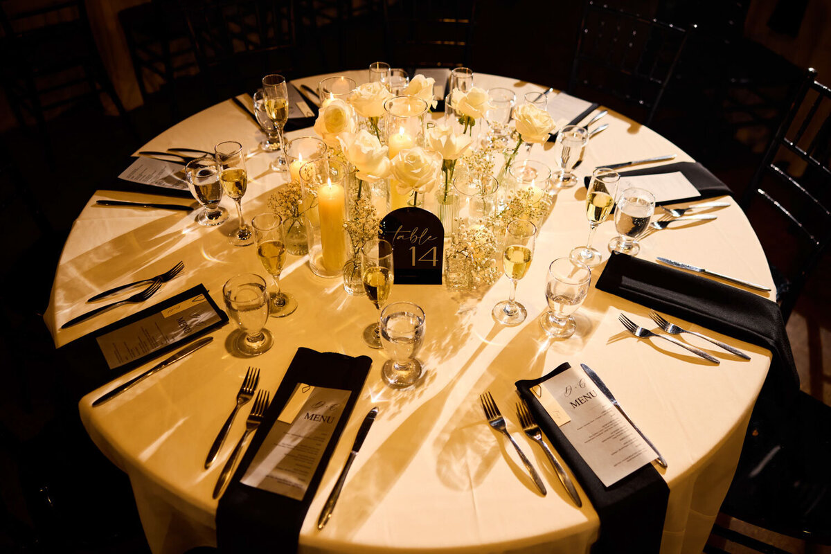 Wedding table designed with white flowers and black napkins