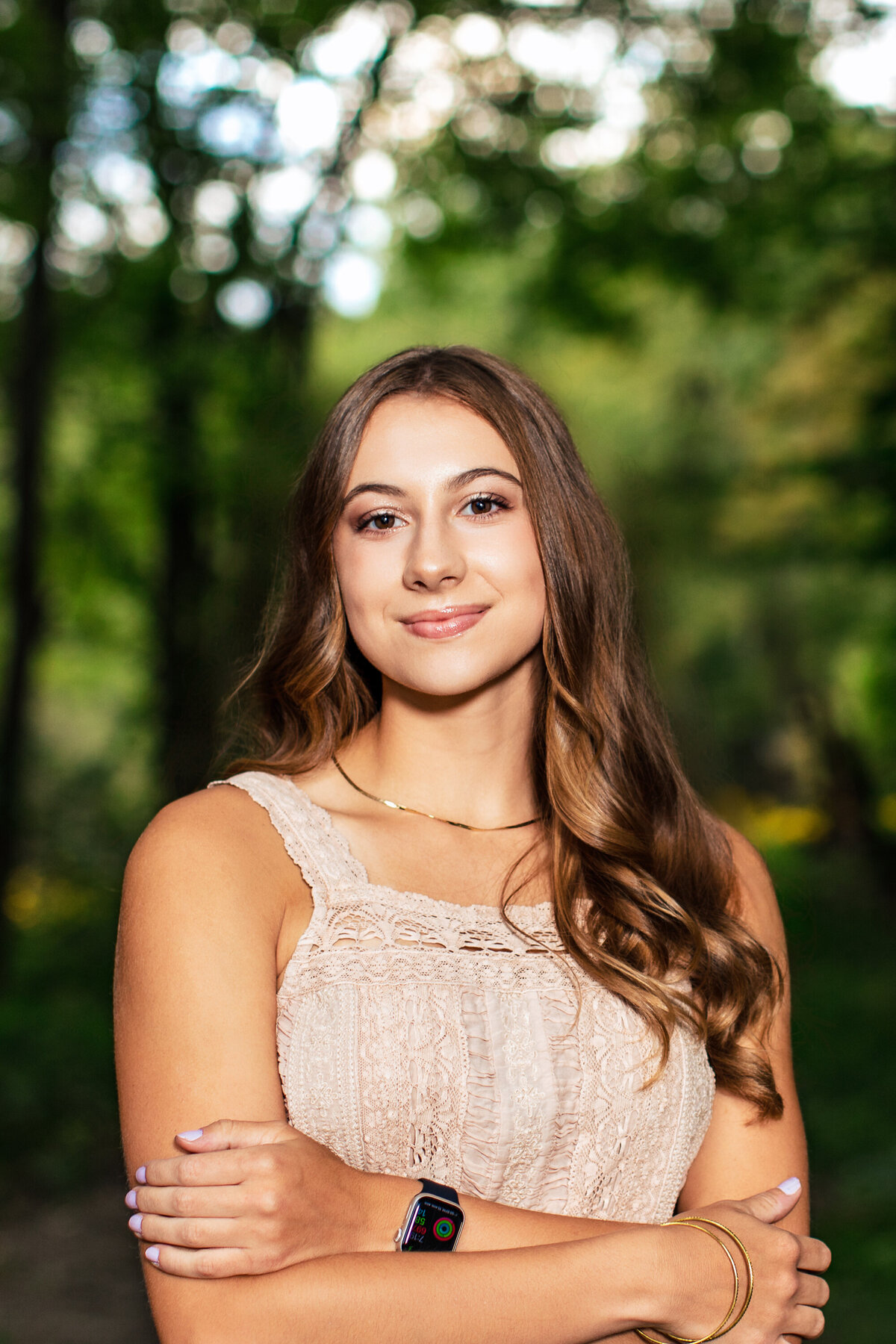 Smooth haired brown eyed girl poses wearing a lace top in the woods near Pittsburgh Pennsylvania