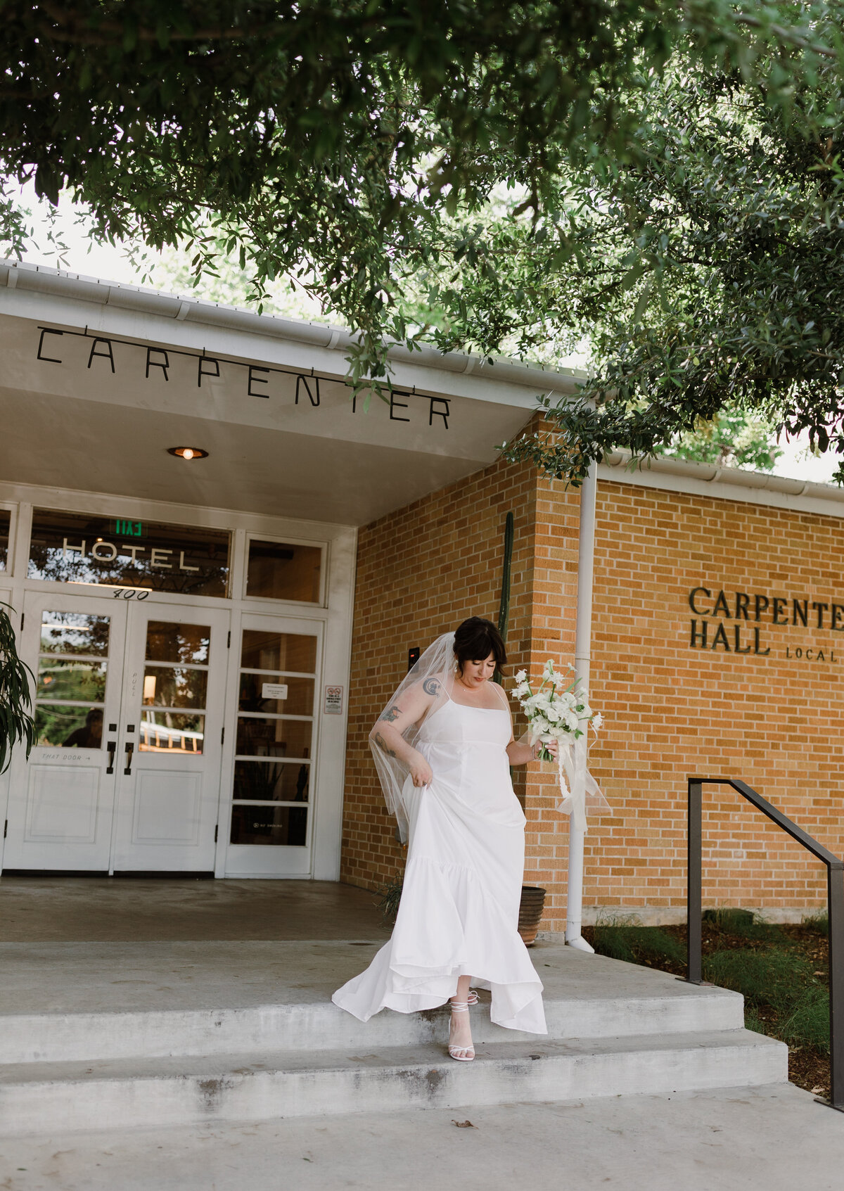 Bride walking down the steps outside the Bride and groom portraits at  Carpenter Hotel, Austin