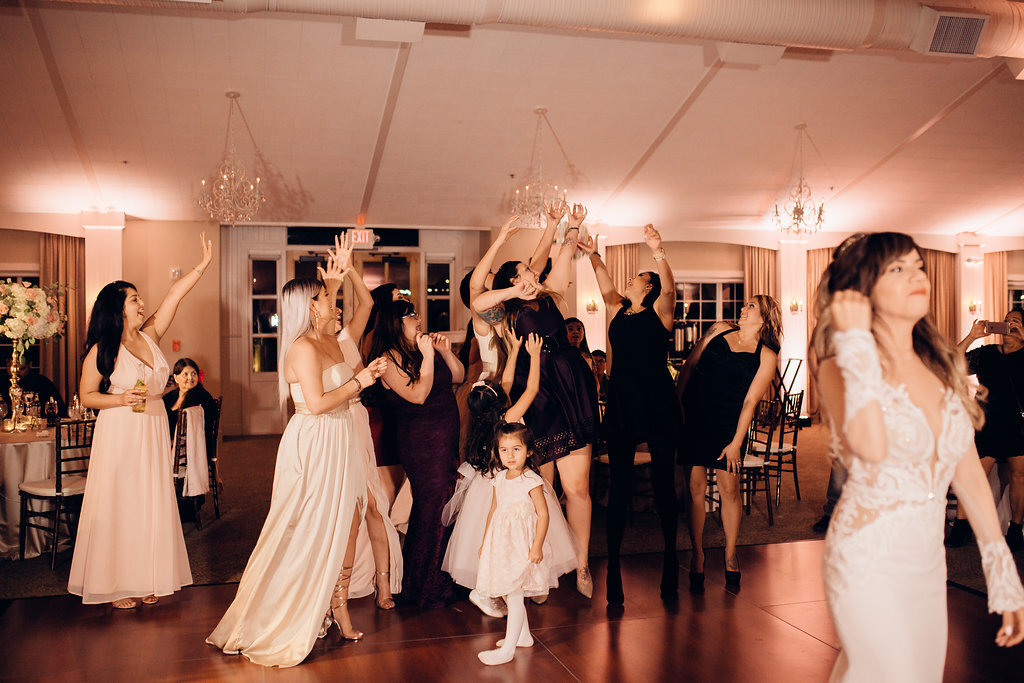 Wedding Photograph Of Women In White And Maroon Dresses Raising Their Hands Los Angeles