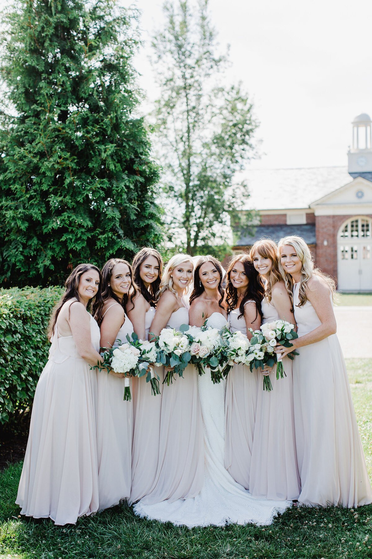 An image capturing a warm moment of bridesmaids hugging each other, likely representing friendship and support on the wedding day