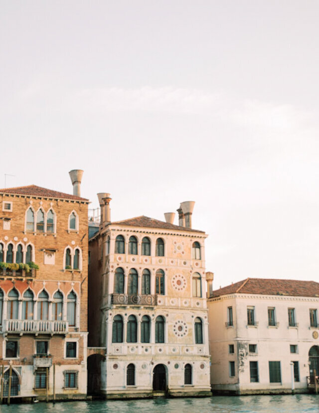 A serene view of Venice's iconic waterfront buildings, adding a sense of timeless elegance to the engagement session.