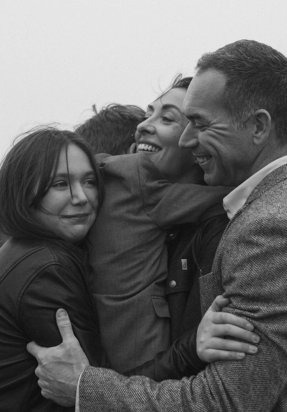 joyful family moment with mom, dad, and two kids being silly and enjoying each other's company in Bend