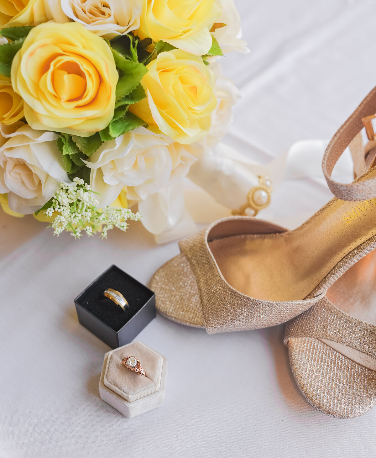 bridal shoes, wedding rings and yellow bridal bouquet in Arlington Virginia by destination wedding photographer Amanda Richardson Photography