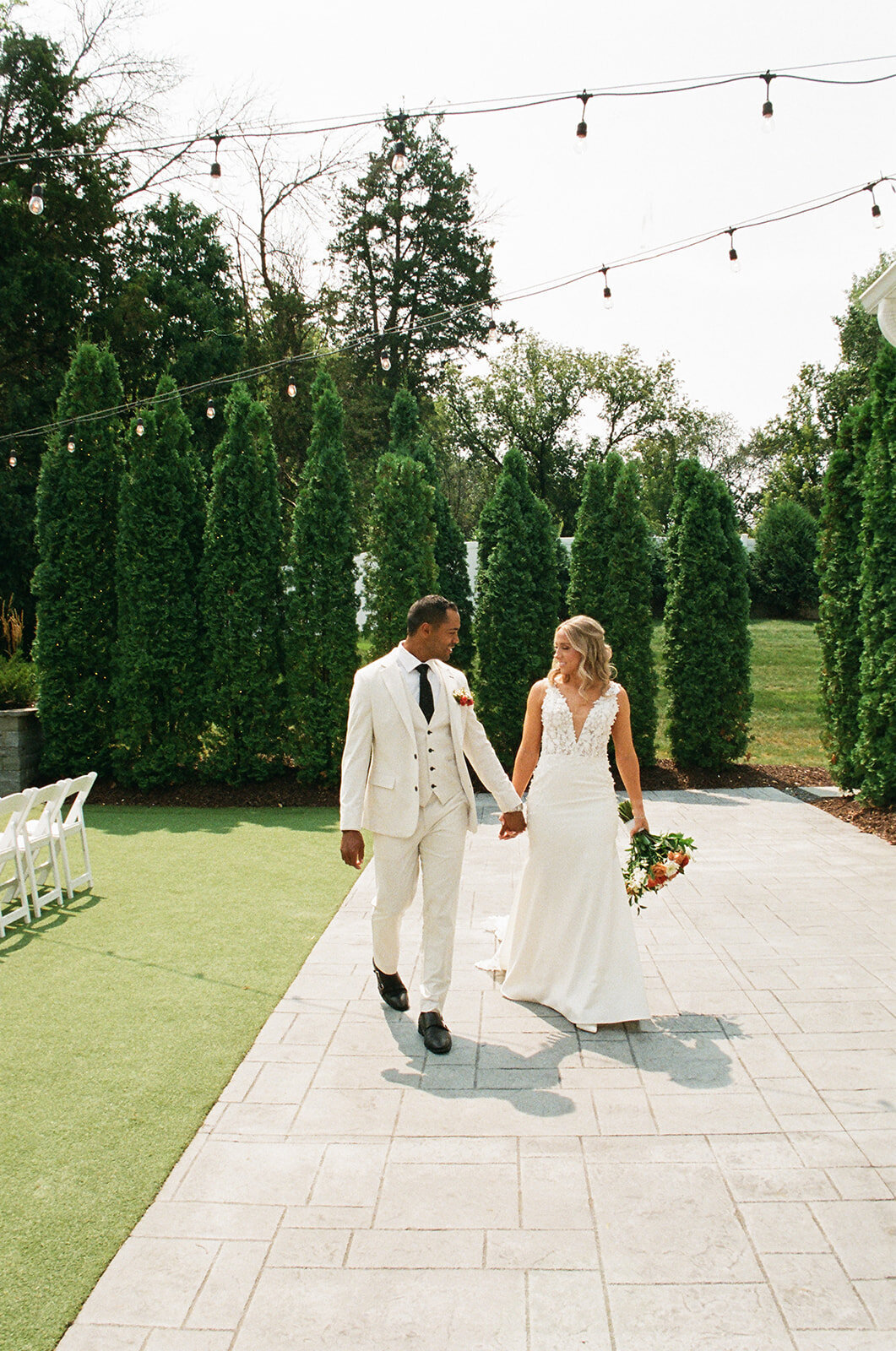 couple walking together holding hands on their wedding day