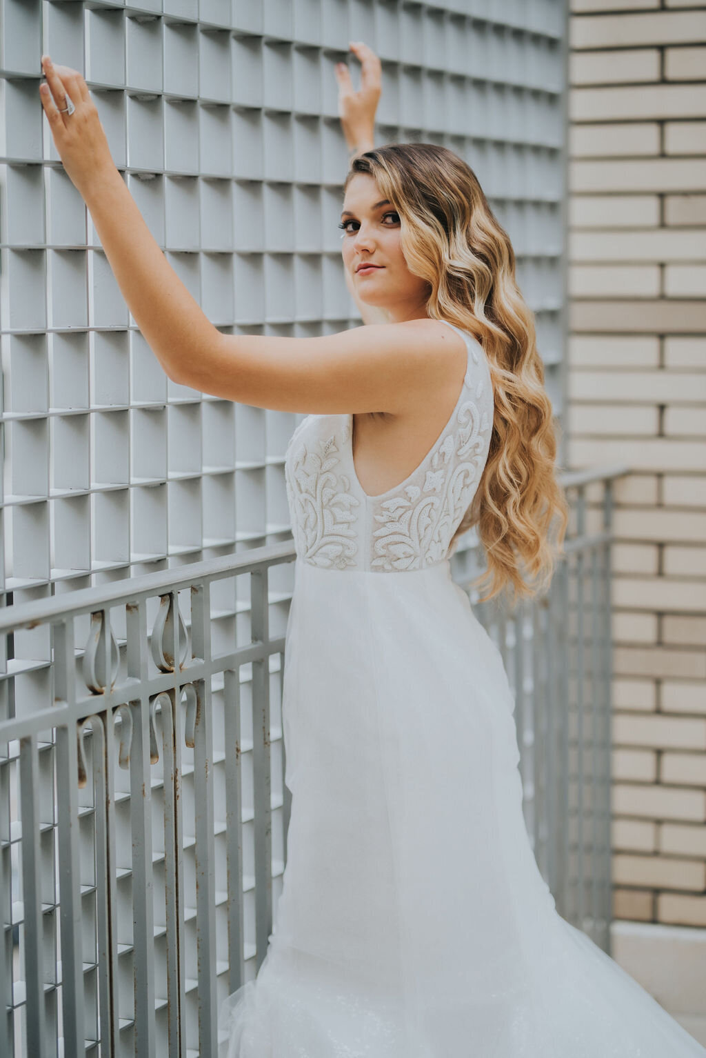 The all-over beaded, sleeveless bodice is paired with a sequin mermaid skirt for a sparkling wedding dress look from top to bottom.