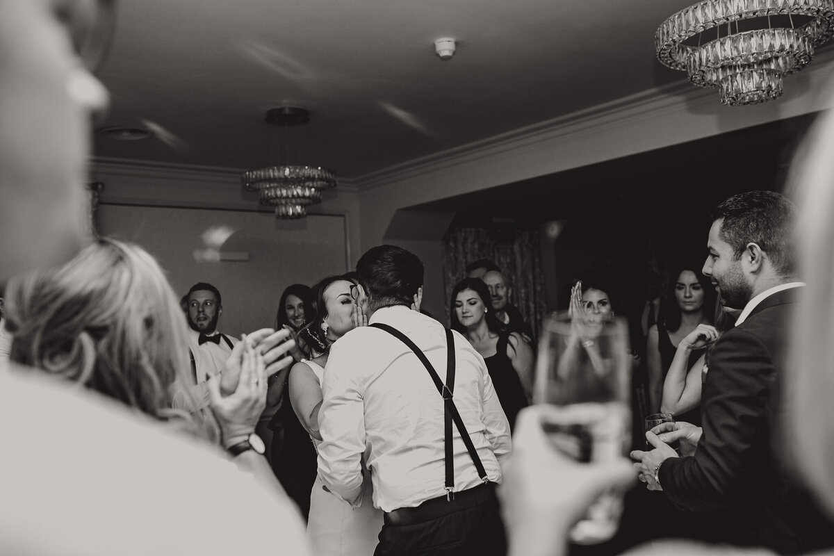 Bride and groom kissing on the dancefloor