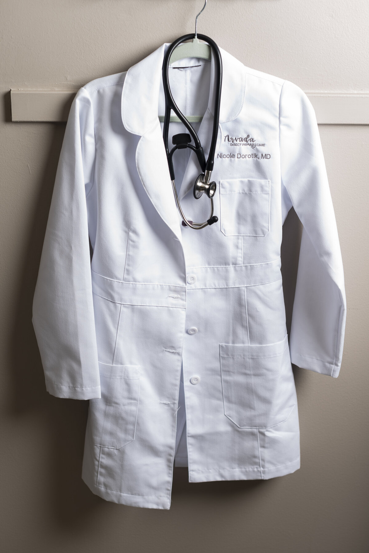 a white medical doctor coat hanging up