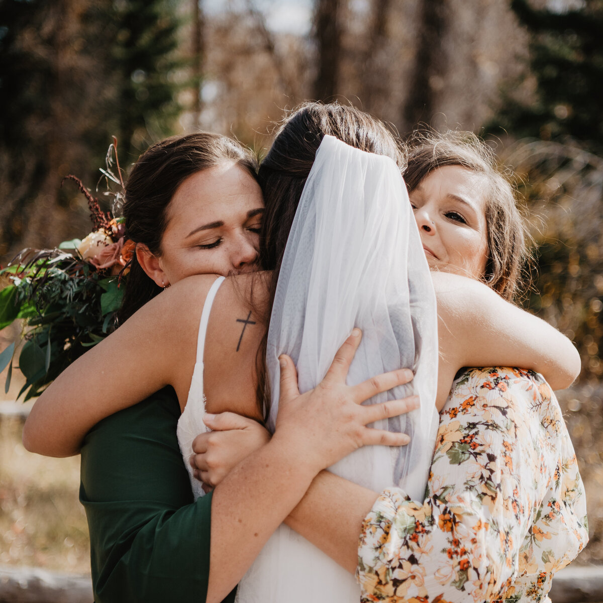Photographers Jackson Hole capture bride hugging family