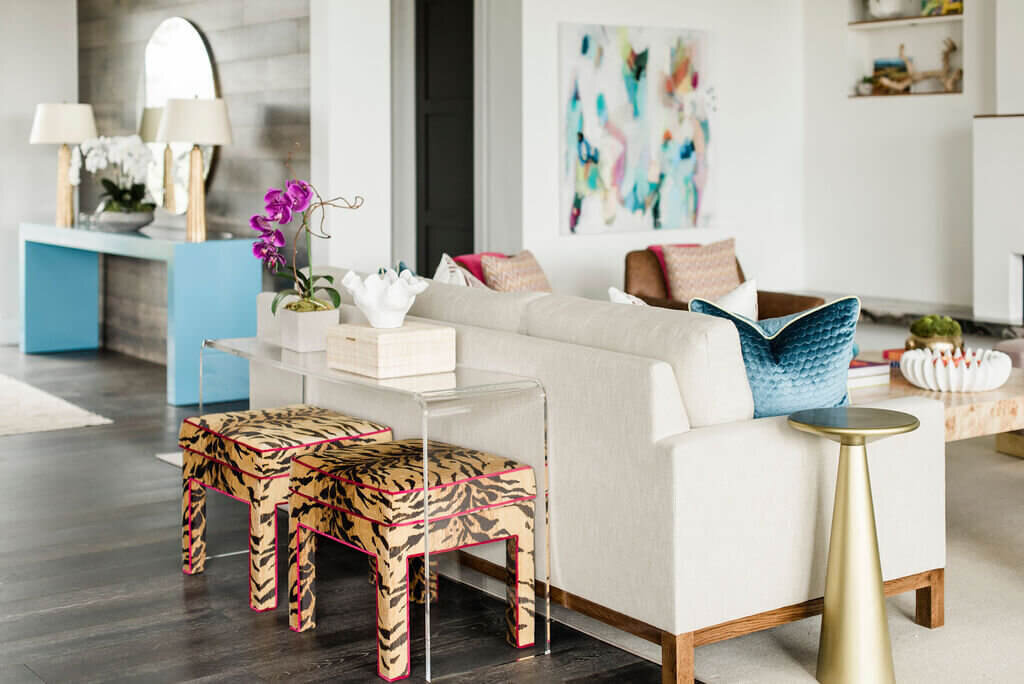 oyster creek studios austin barton creek tiger pattern stools with gold table and white sofa in living room with abstract art