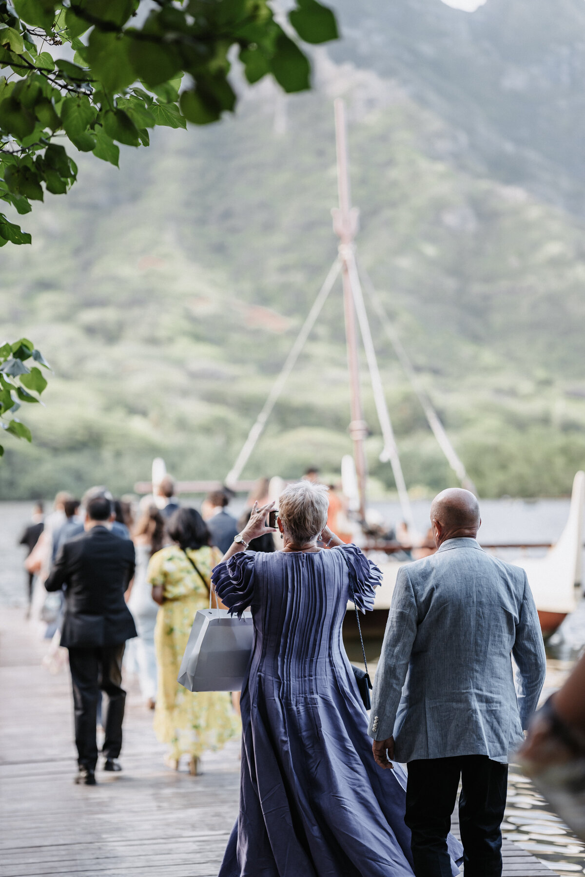 Guests walking to the Kualoa Ranch transportation boat with koolau mountains in the background