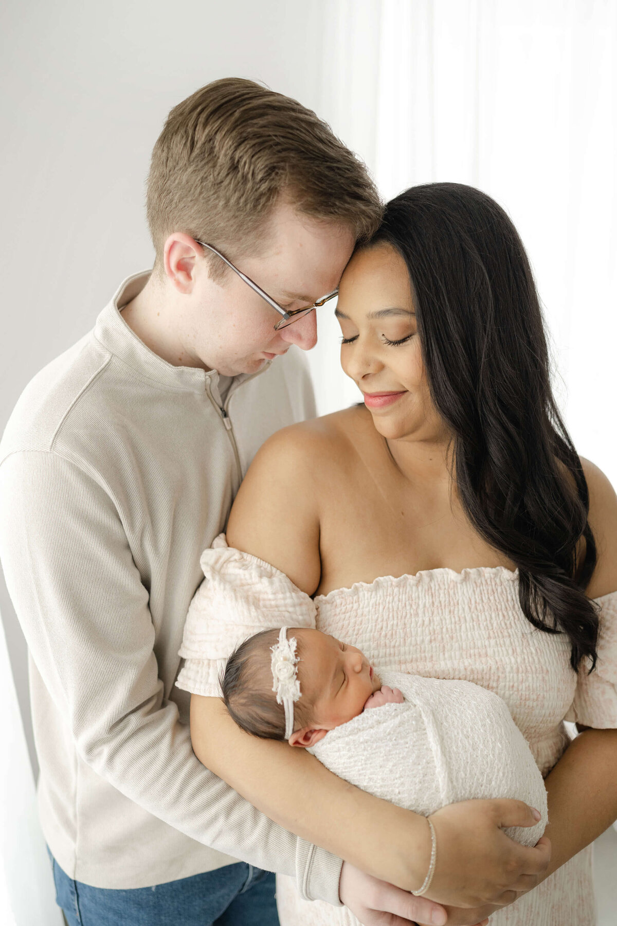 intimate moment of oklahoma city newborn parents snuggling their precious new daughter
