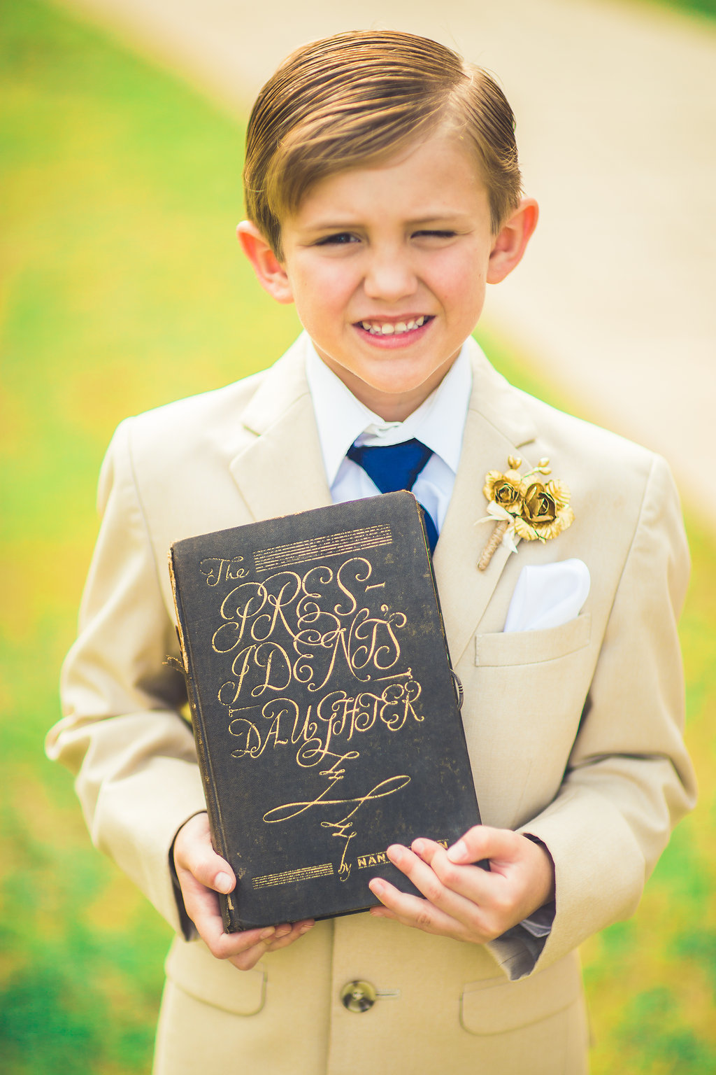 Wedding Photograph Of a Boy in Brown Suit Holding a Book Los Angeles