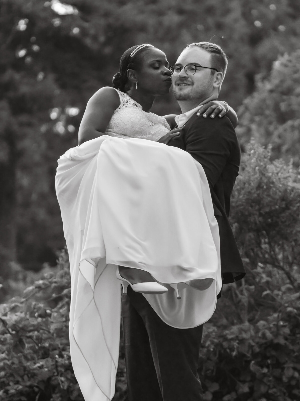Black and white photo of a romantic moment with bride and groom at their wedding
