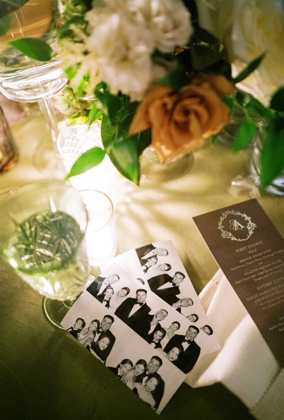 Photo of the table with a menu and group photos of the guests. 