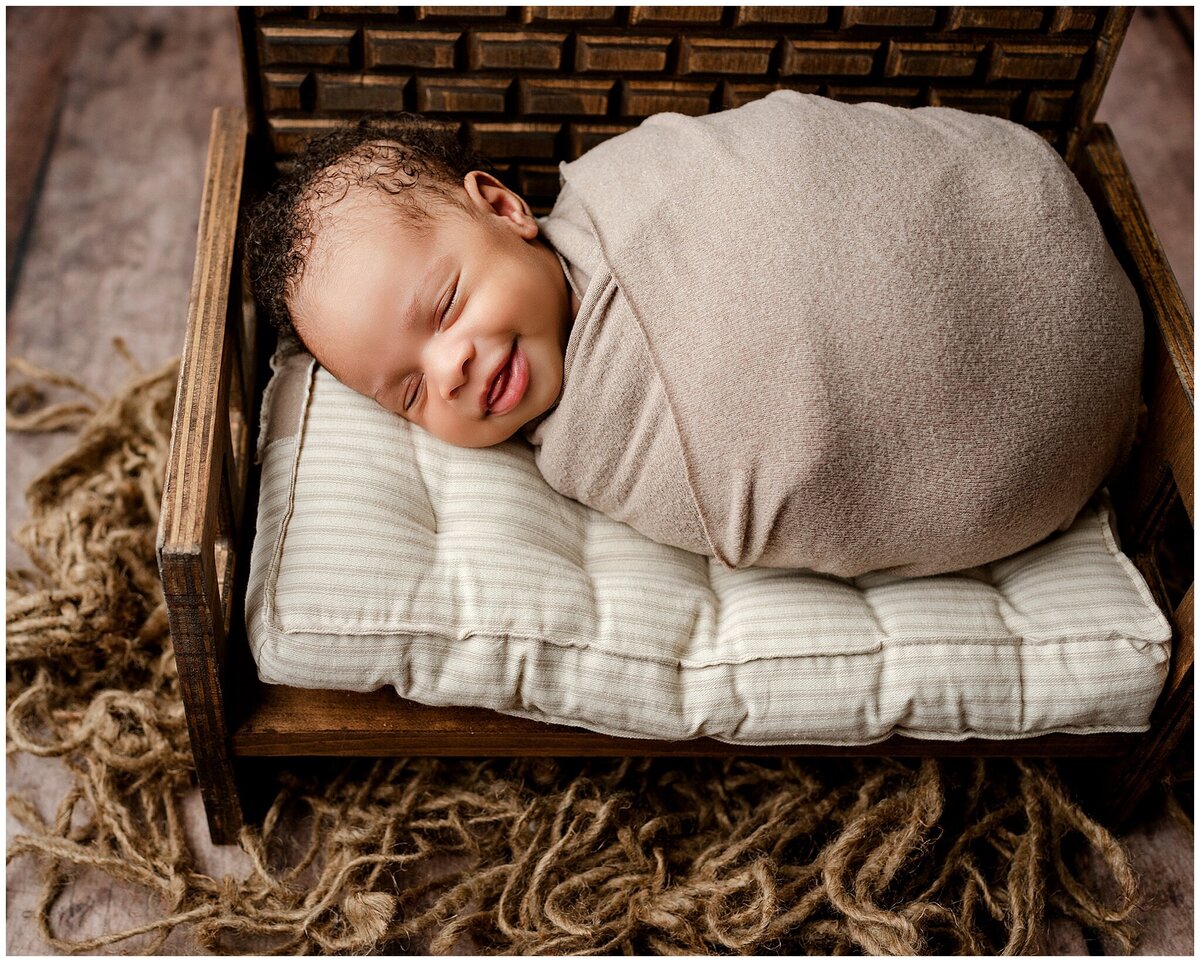 baby wrapped laying on bench prop