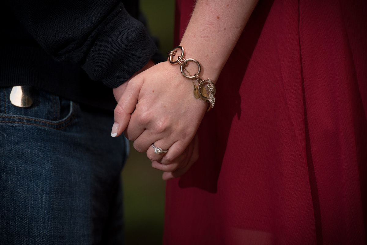 Close up of engagement couple holding hands