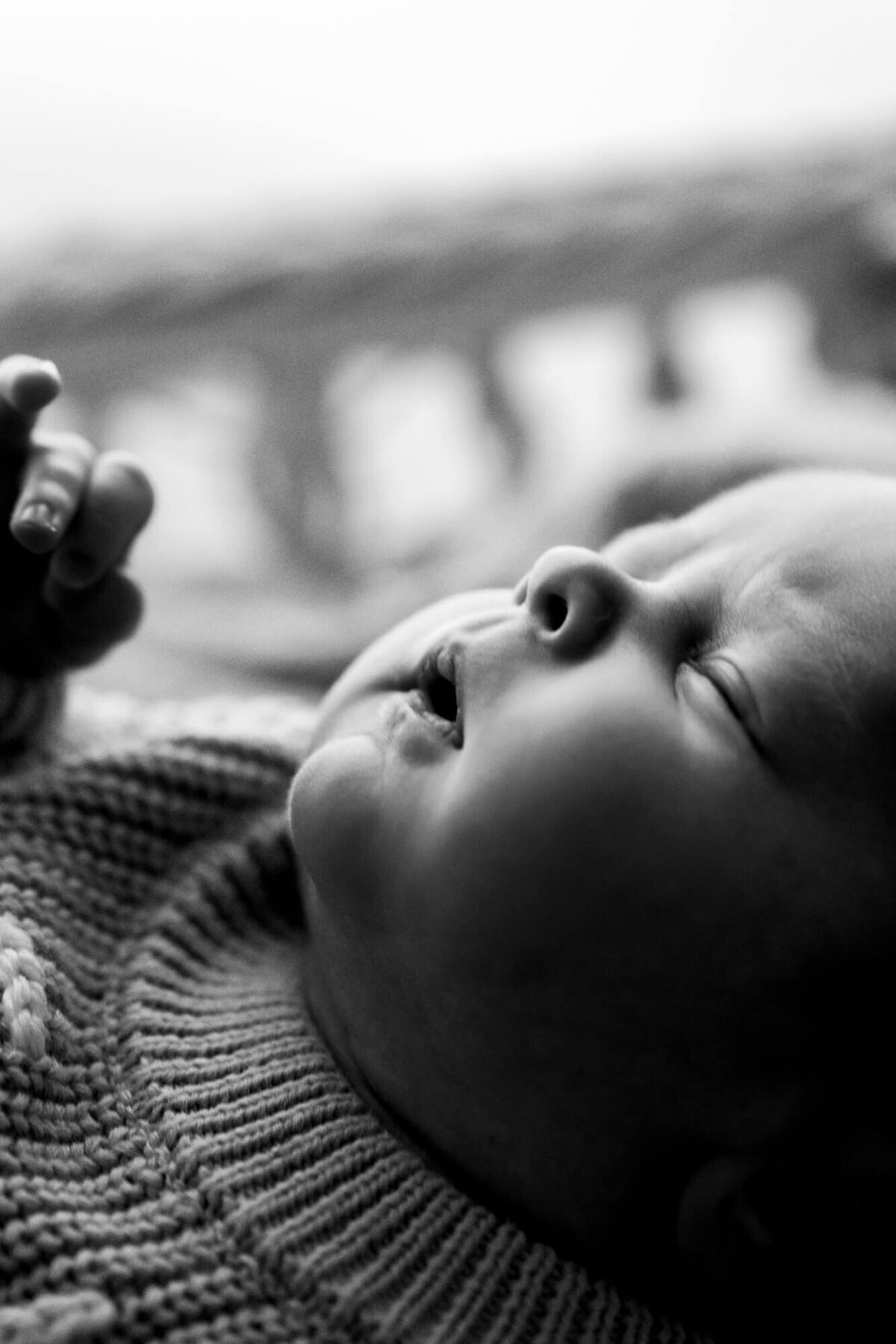 Black and white profile photo of a one week old baby boy.