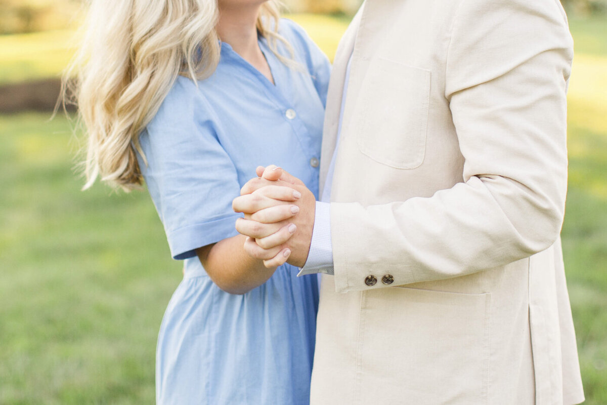 closeup of bride and groom holding hands