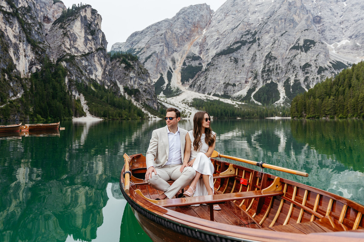 Groom and bride sitting boat Lago di Braies