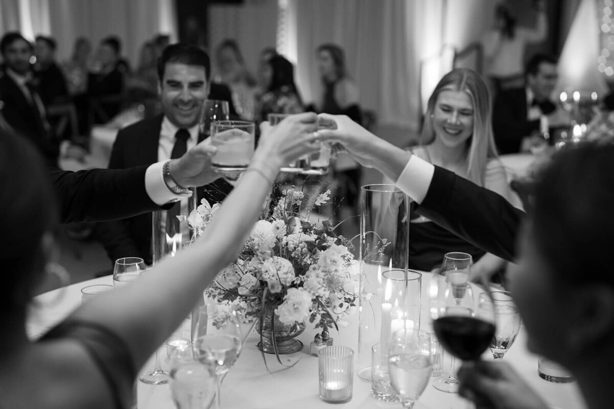 Guests raise their glasses in celebration of the newly wed couple at the Aspen Meadows Resort wedding reception venue.
