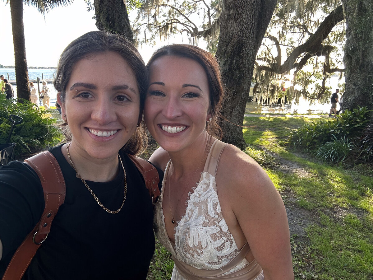 Smiling photographer with a bride in an outdoor garden setting at Lakeside Inn, Mount Dora, Florida.