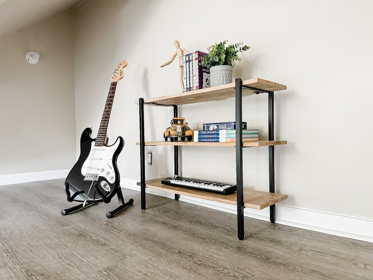 Electric guitar next to styled sofa table