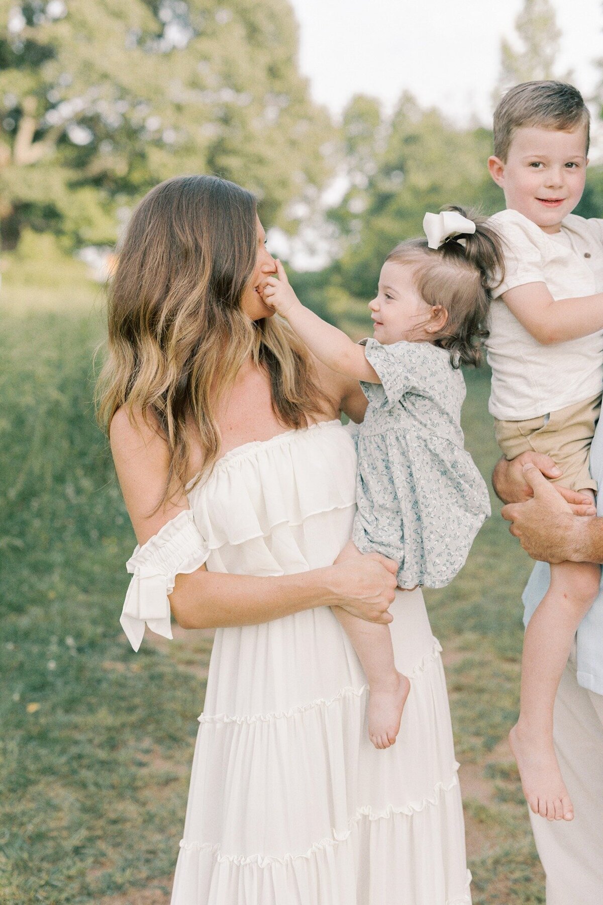 little-girl-pointing-to-moms-nose