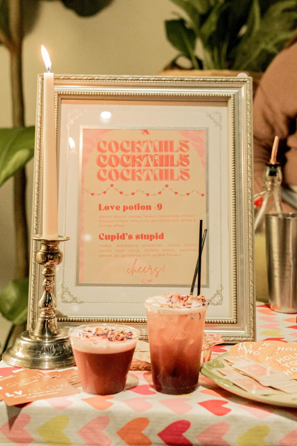 Cocktail menu at event with two cocktails in front of it