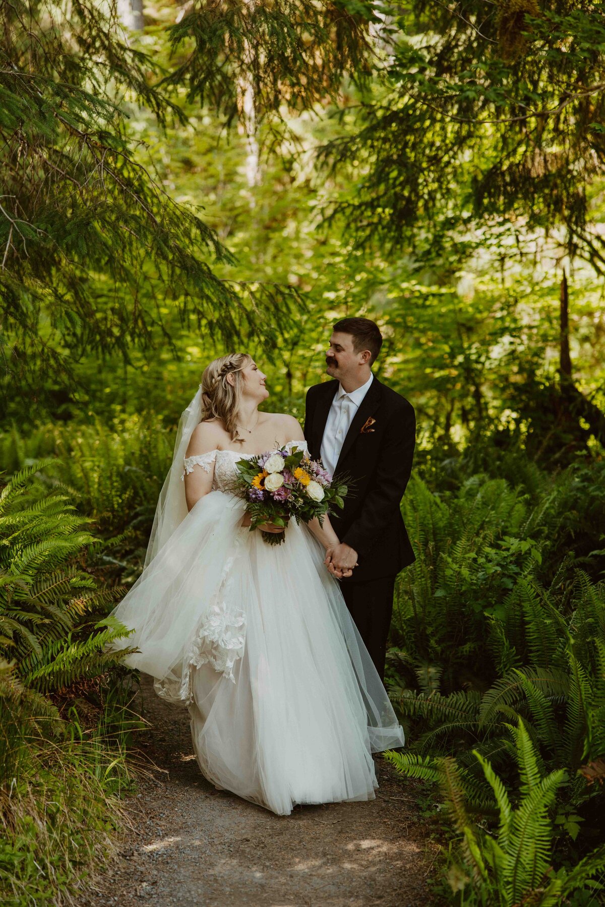 Bride standing on deep washington forrest 