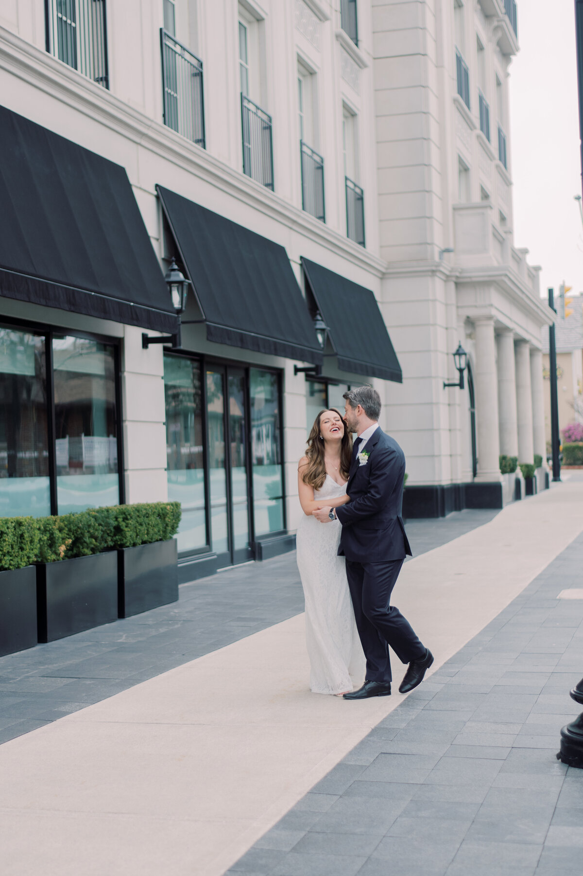 Bride and Groom sharing a laugh down the street in Oakville.