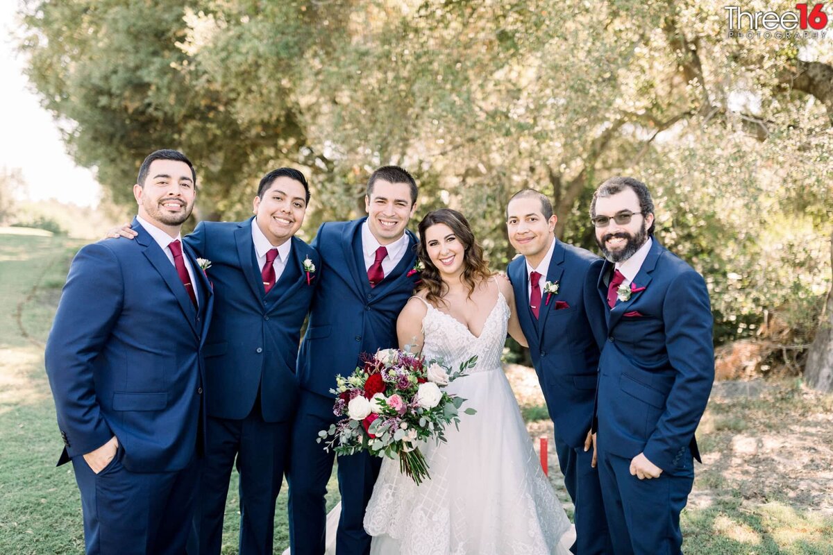 Bride poses with the Groomsmen