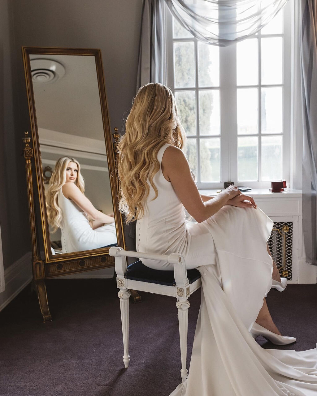 Behind the scenes: Yana styling bride’s hair and makeup before the ceremony in Marin County, California.